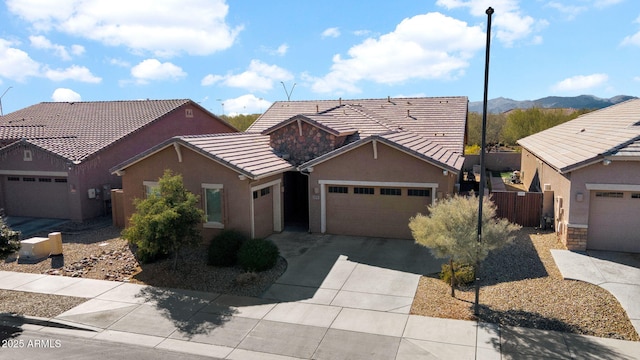 ranch-style home featuring a garage and a mountain view