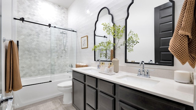 full bathroom featuring vanity, toilet, and combined bath / shower with glass door