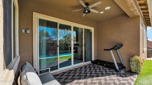 exercise area with carpet flooring and ceiling fan