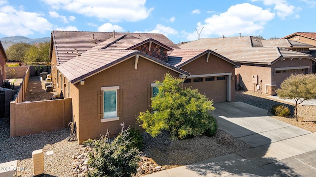 view of front of property with a garage and a mountain view