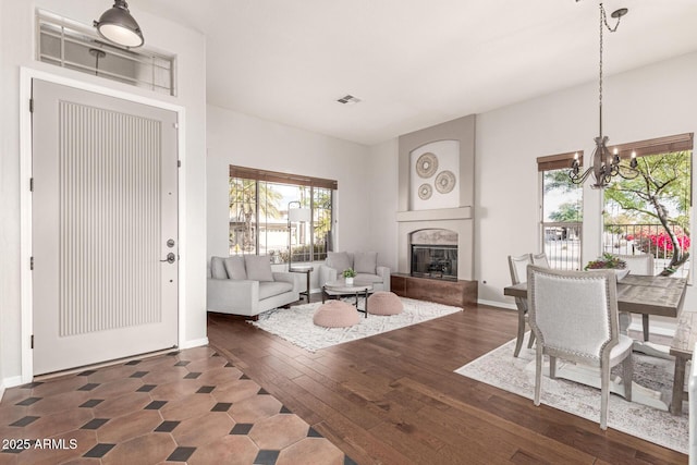 living room with an inviting chandelier and dark hardwood / wood-style flooring