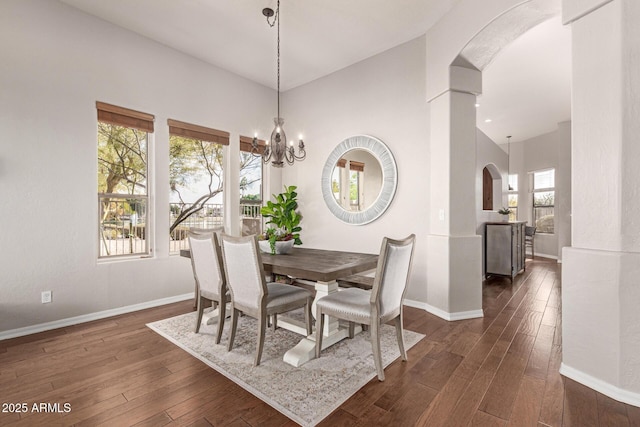 dining space featuring dark hardwood / wood-style flooring and a notable chandelier