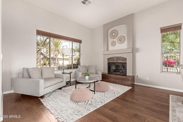 living room with dark hardwood / wood-style flooring and a fireplace