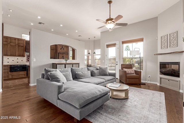 living room with dark hardwood / wood-style floors and ceiling fan