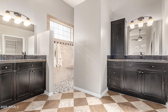 bathroom with ceiling fan, vanity, and a tile shower