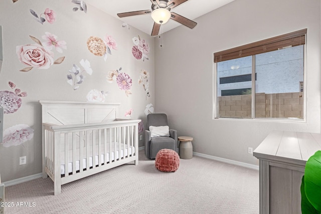 bedroom featuring light colored carpet and a nursery area