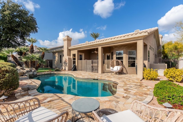 view of swimming pool featuring a patio area and ceiling fan