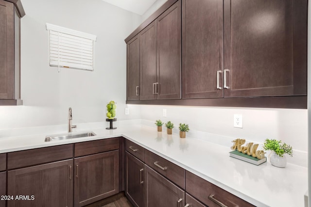 kitchen featuring dark brown cabinetry and sink