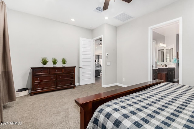 bedroom with light carpet, ensuite bath, ceiling fan, and sink