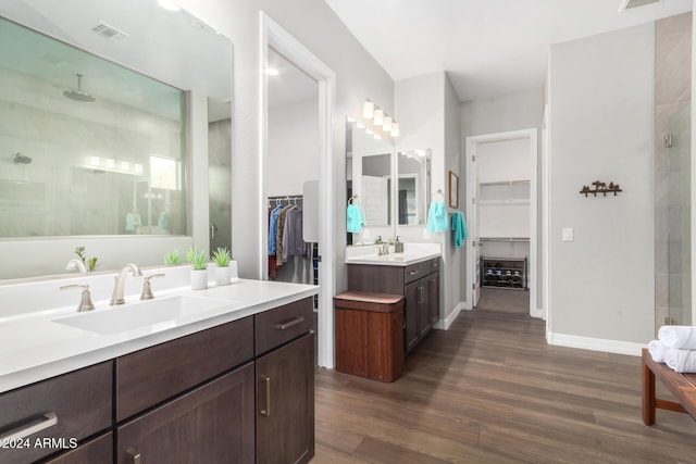 bathroom featuring a shower, vanity, and hardwood / wood-style flooring