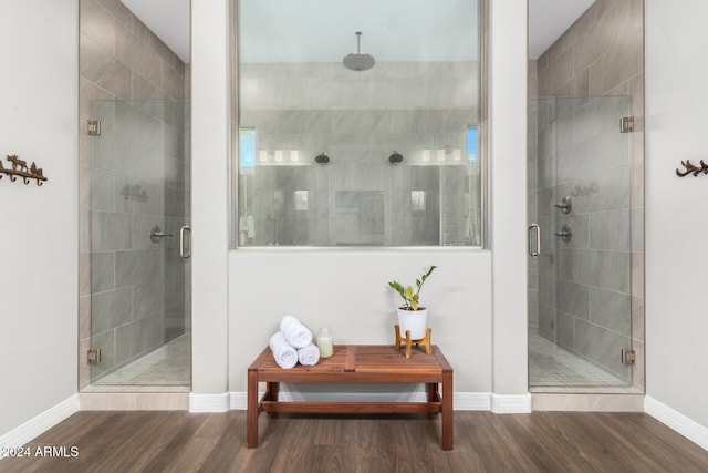 bathroom with hardwood / wood-style flooring and a shower with door