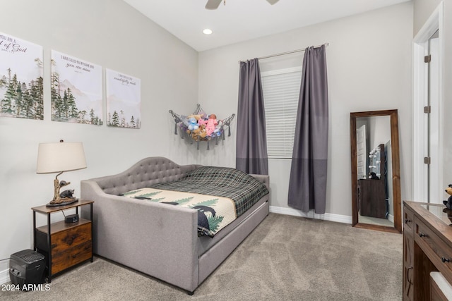 bedroom with ceiling fan and light colored carpet