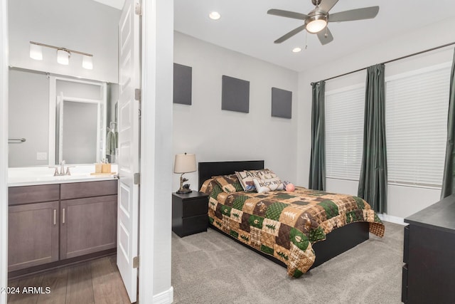 bedroom featuring ceiling fan, sink, and connected bathroom