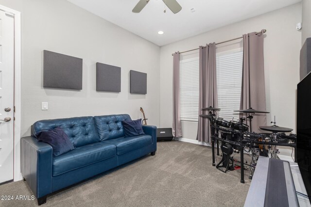 carpeted living room with ceiling fan