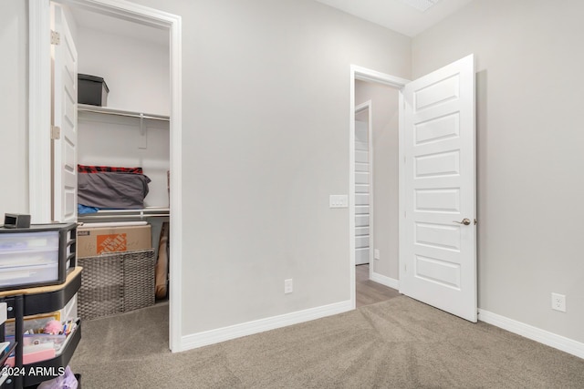 unfurnished bedroom featuring carpet flooring and a closet