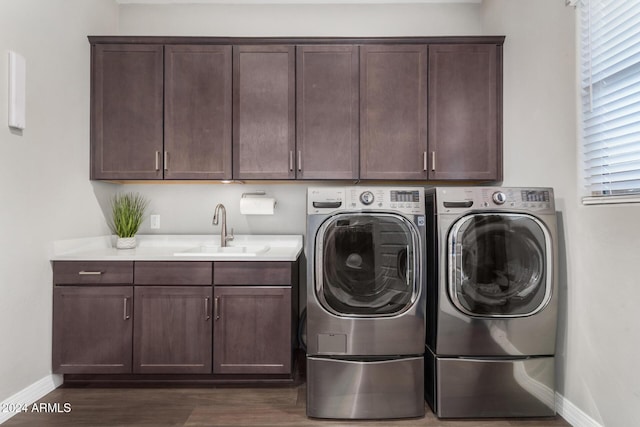 laundry room with dark hardwood / wood-style floors, cabinets, sink, and washing machine and dryer