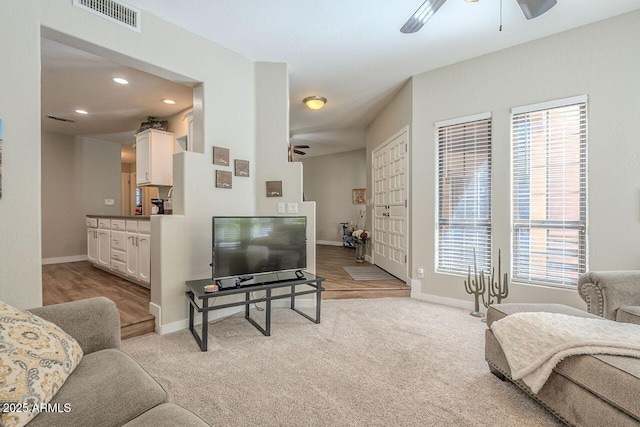 living room with visible vents, baseboards, light carpet, recessed lighting, and a ceiling fan