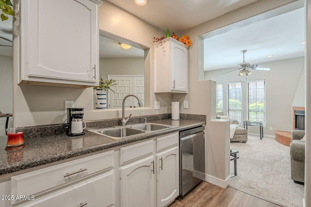 kitchen with a sink, white cabinets, ceiling fan, and stainless steel dishwasher