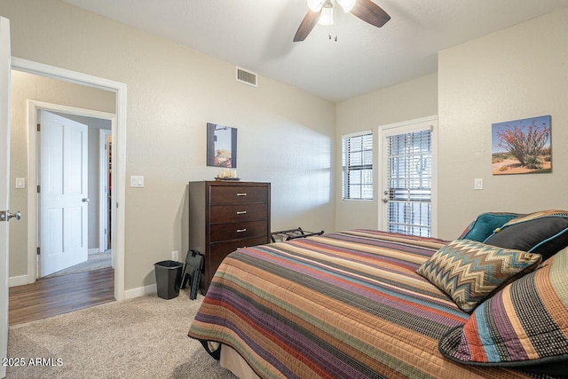 bedroom with visible vents, carpet floors, baseboards, and ceiling fan