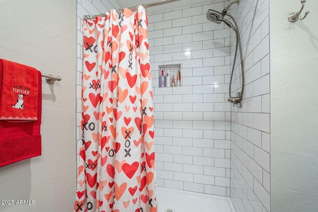 full bathroom featuring a stall shower and a textured wall