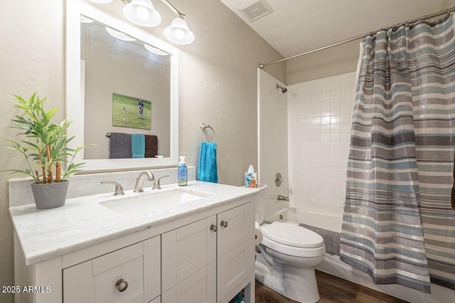 full bath with visible vents, toilet, shower / bath combo, wood finished floors, and vanity