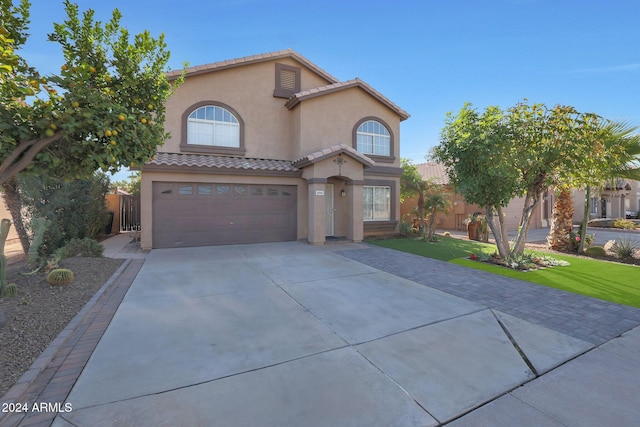 view of front of property featuring a garage and a front lawn