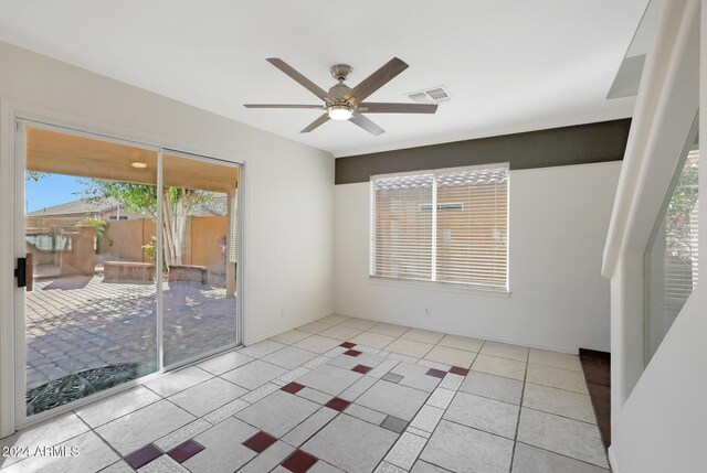 empty room featuring ceiling fan and light tile patterned flooring