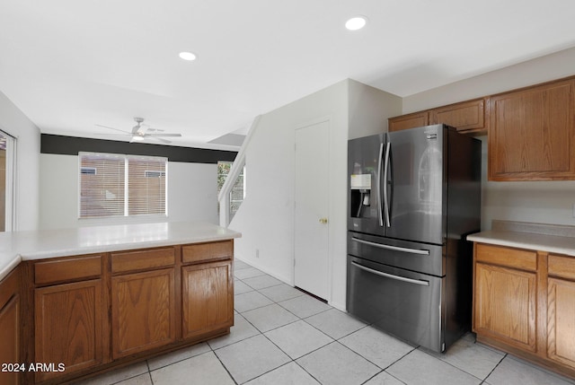 kitchen with stainless steel fridge, light tile patterned floors, and ceiling fan