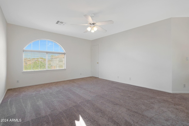 carpeted spare room featuring ceiling fan