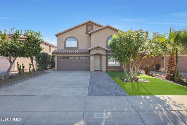 view of front of house featuring a front yard and a garage