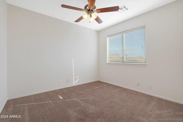 spare room featuring carpet flooring and ceiling fan