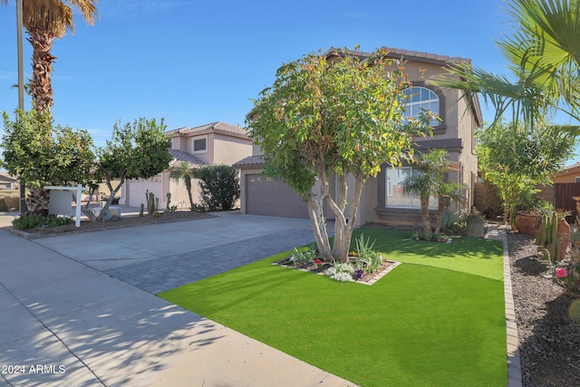 mediterranean / spanish home featuring a front yard and a garage