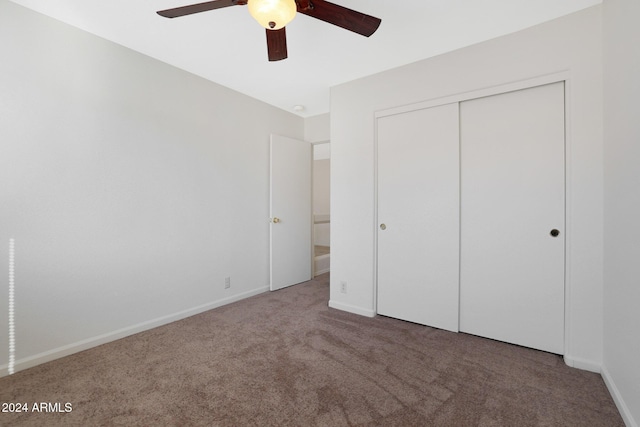 unfurnished bedroom with ceiling fan, a closet, and carpet floors