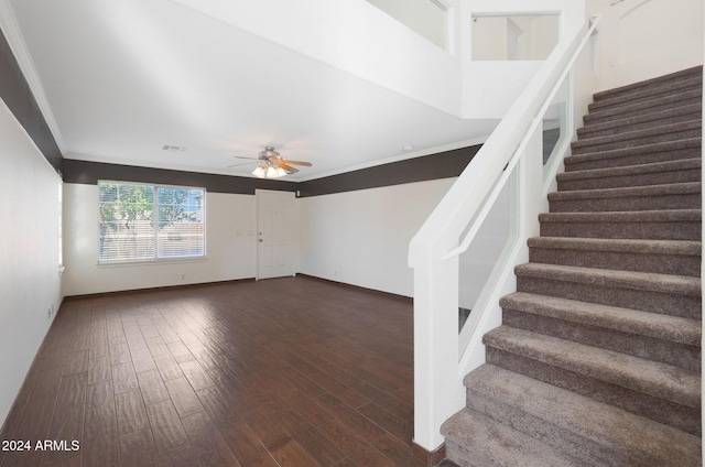 interior space with dark hardwood / wood-style floors, ceiling fan, and crown molding