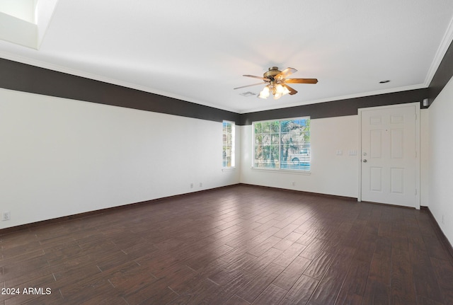 spare room with ornamental molding, ceiling fan, and dark wood-type flooring