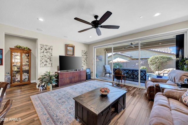 living room featuring ceiling fan and wood-type flooring