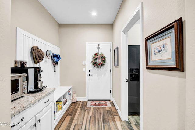 mudroom with wood-type flooring