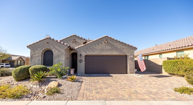 mediterranean / spanish-style home featuring a garage