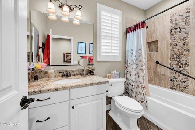 full bathroom with vanity, a chandelier, shower / bath combination with curtain, and toilet