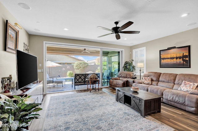 living room with ceiling fan and hardwood / wood-style floors