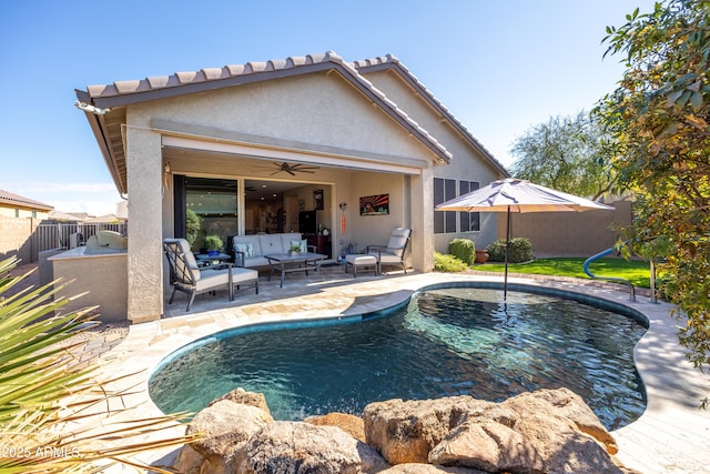 view of swimming pool with outdoor lounge area, area for grilling, ceiling fan, and a patio area