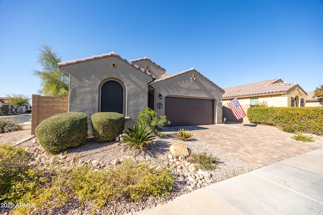 mediterranean / spanish-style house with a garage