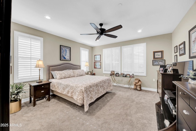 bedroom with ceiling fan and light colored carpet