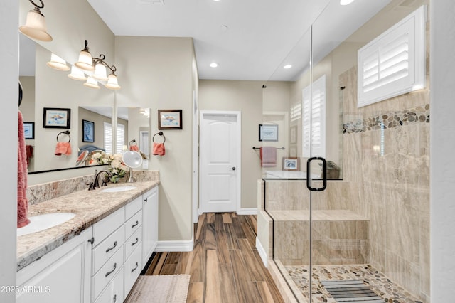 bathroom featuring vanity, an enclosed shower, and hardwood / wood-style floors