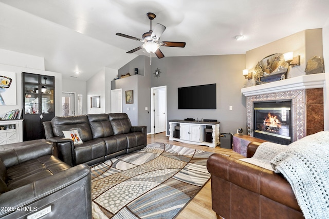 7300 Butte Vis, Prescott Valley, AZ 86315 - living room with lofted ceiling, wood finished floors, a ceiling fan, and a tile fireplace