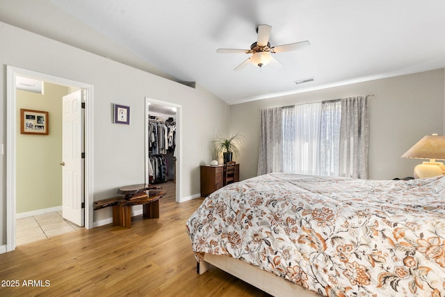 7300 Butte Vis, Prescott Valley, AZ 86315 - bedroom with visible vents, light wood finished floors, baseboards, vaulted ceiling, and a walk in closet