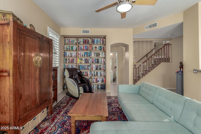 tiled living room with ceiling fan