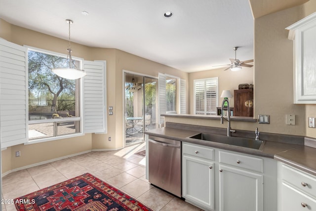 kitchen featuring white cabinetry, dishwasher, sink, and decorative light fixtures