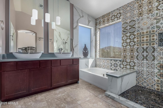 bathroom featuring tile patterned flooring, vanity, and separate shower and tub