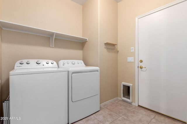 clothes washing area featuring washing machine and dryer and light tile patterned flooring